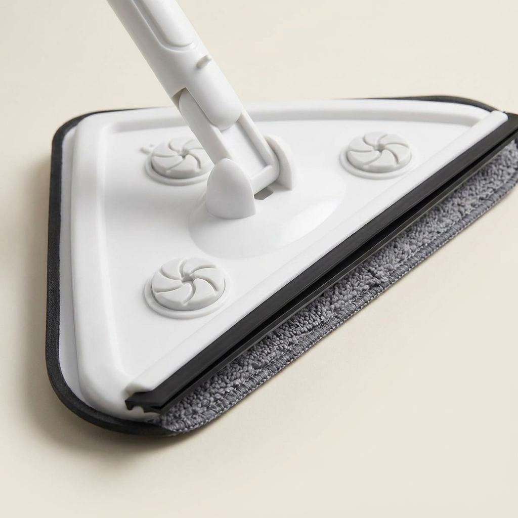 Close-up of the TidyLark mop's triangular swivel head and gray microfiber pad
